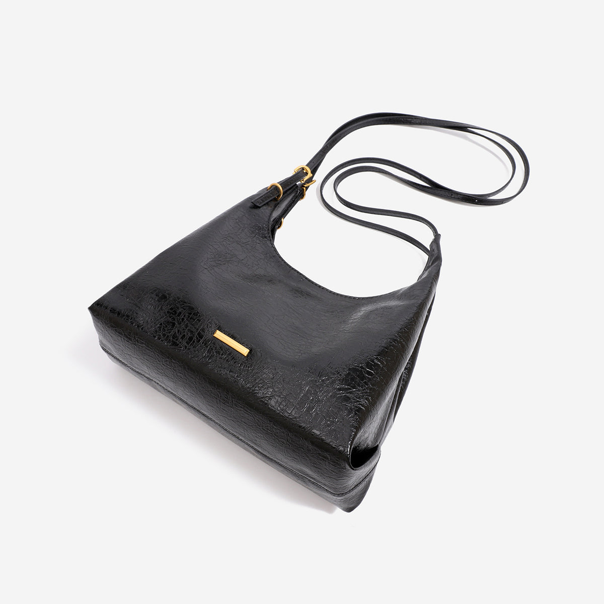 Slouchy hobo shoulder bag in crinkle high-gloss leather-look finish with gold-tone bar hardware and adjustable strap, detail
