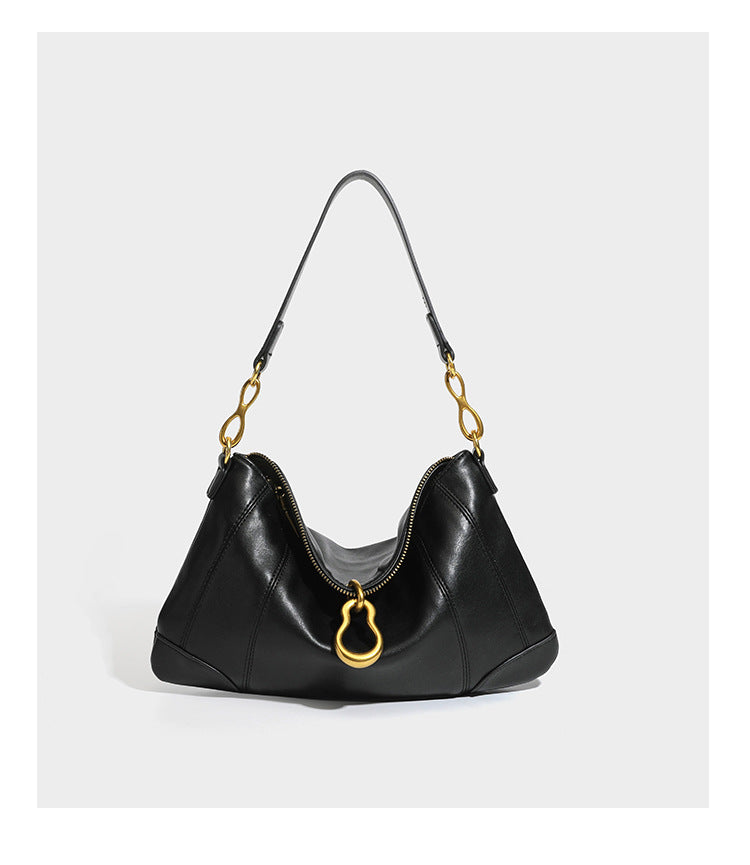 Slouchy denim shoulder bag with dark leather-look trim, gold-tone chain-link hardware, and top zipper closure, detail view 13