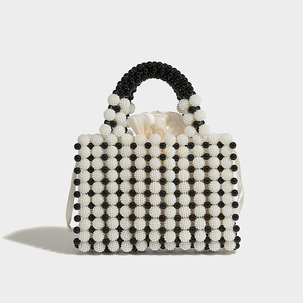 Small boxy pearl-bead mini top-handle bag with silver metallic bead accents, satin floral detail, and long beaded shoulder