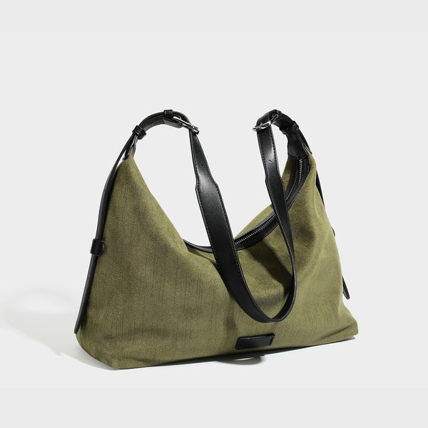 Slouchy olive green canvas hobo shoulder bag with black leather-look trim, zip-top closure, and adjustable strap, detail view