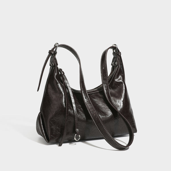 Slouchy hobo shoulder bag in glossy crinkled leather-look finish with zip-top closure and silver-tone ring hardware, detail