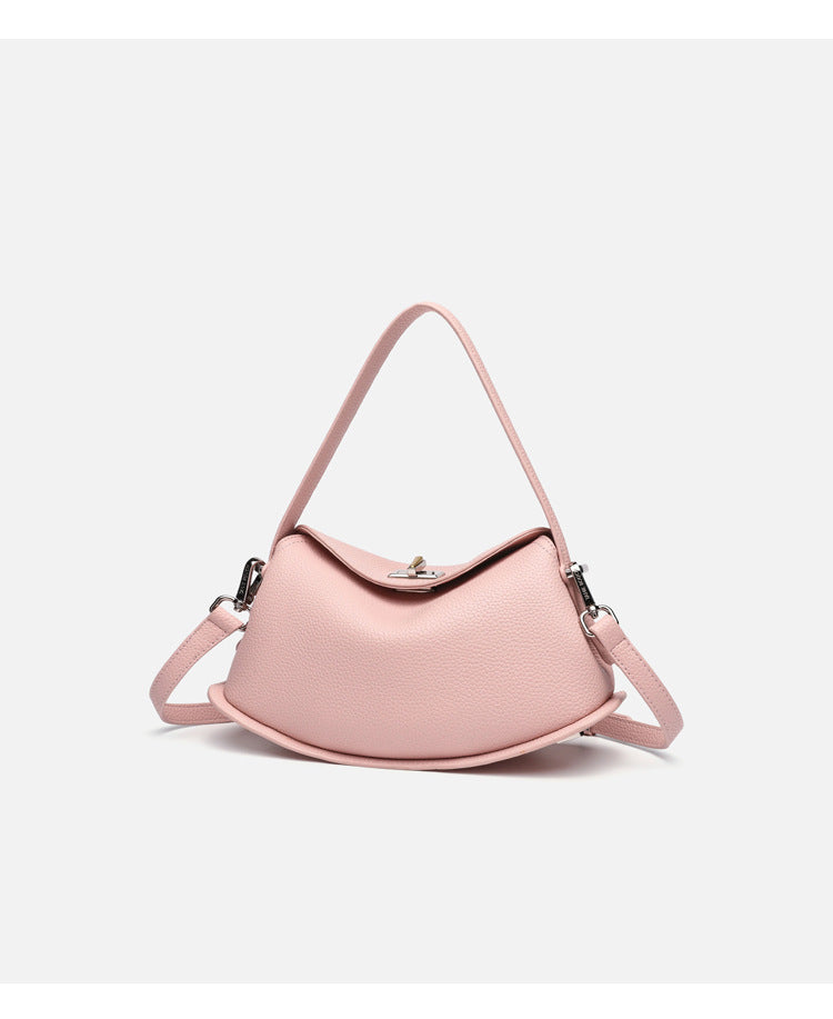 Pebbled leather-look half-moon saddle bag with turn-lock flap closure, top handle, and detachable crossbody strap, detail