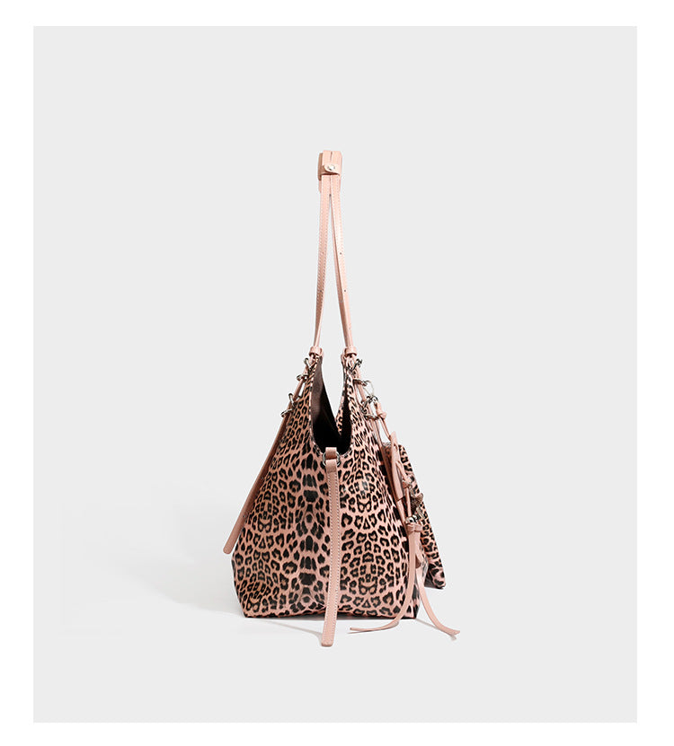 Large leopard print shoulder tote bag with glossy finish, long double straps, front zip pocket, silver-tone hardware, and