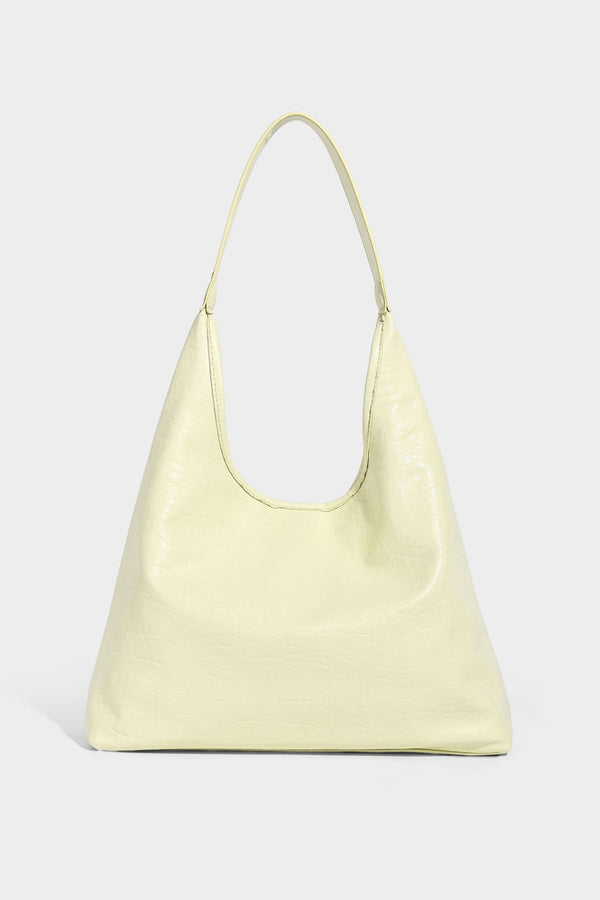 Slouchy hobo shoulder bag in pale yellow glossy pebbled leather-look finish with single shoulder strap and detachable front