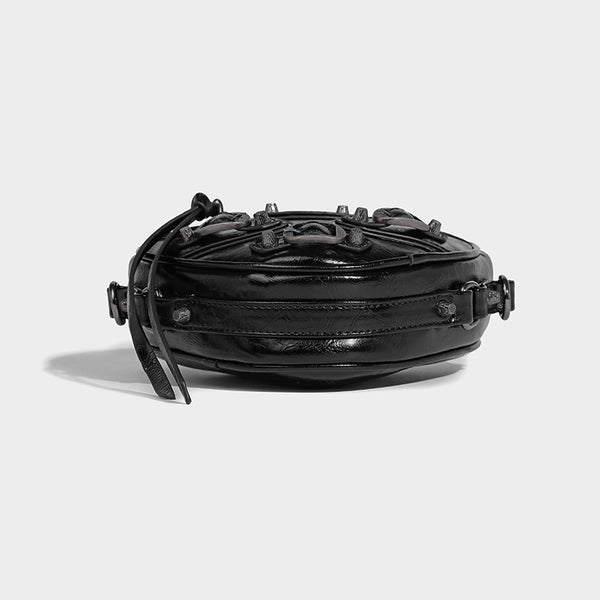 Mini heart-shaped crossbody bag with glossy crinkled finish and moto buckle hardware, detail view 25