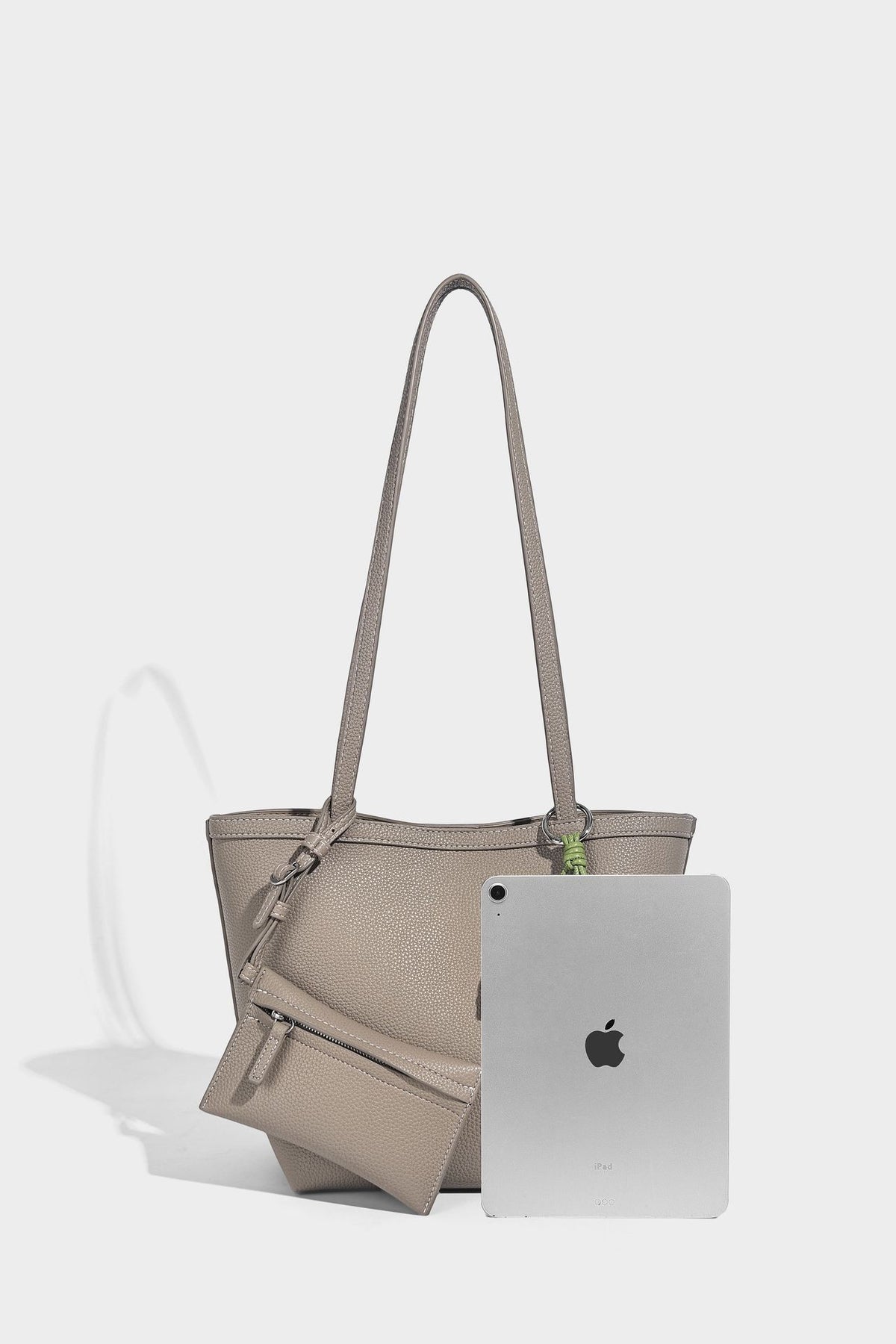 Structured pebbled leather-look tote bag in taupe with long shoulder strap, detachable zip pouch, and pink tulip flower