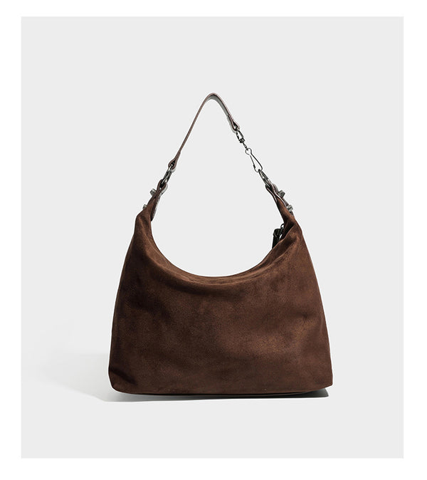 Slouchy suede-finish hobo shoulder bag with dark hardware, exterior zip pocket, tassel ties, and detachable crossbody strap