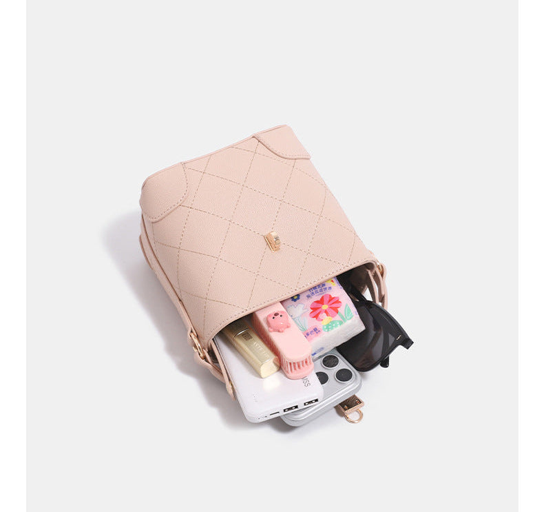 Mini diamond-quilted pebbled-finish bucket bag with gold-tone turn-lock closure and top handle, detail view 8