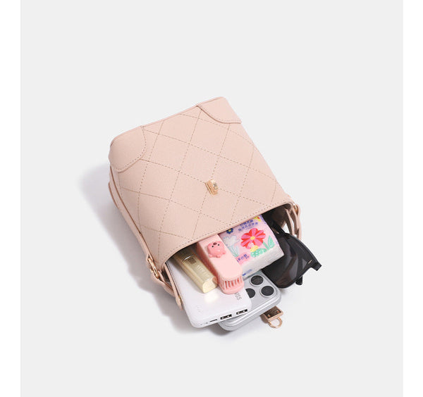 Mini diamond-quilted pebbled-finish bucket bag with gold-tone turn-lock closure and top handle, detail view 8