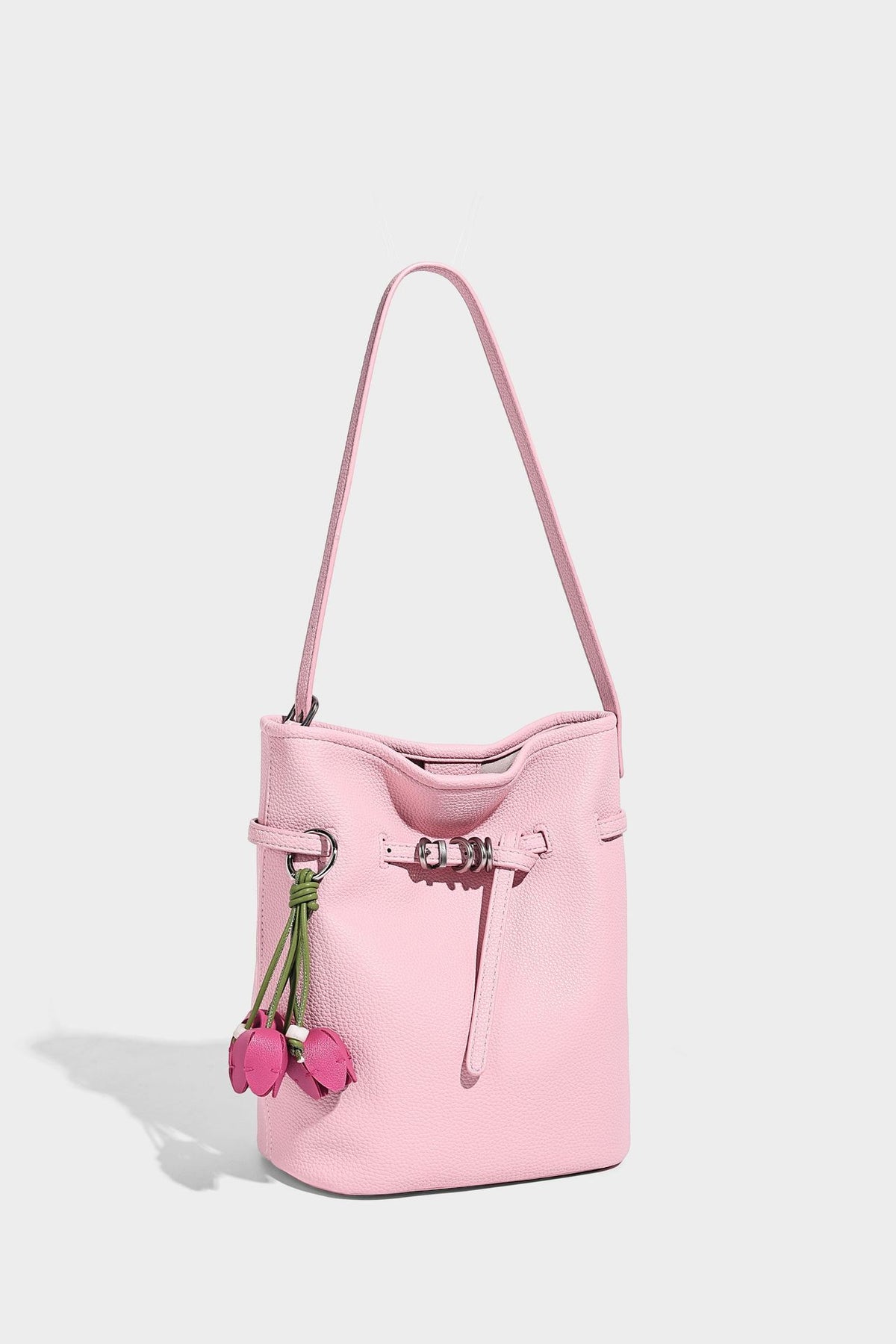 Small pebbled leather-look bucket bag with front drawstring toggle hardware and long adjustable shoulder strap, detail view