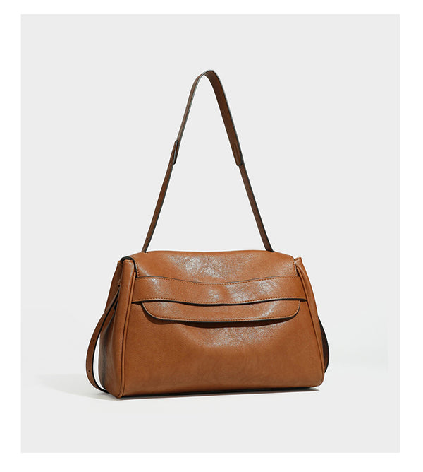 Structured rectangular flap shoulder bag in dark brown leather-look finish with long single strap and layered front panel