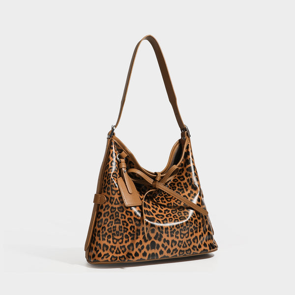 Slouchy leopard print shoulder hobo bag with black leather-look trim, tie-top closure, and single long strap, detail view 3
