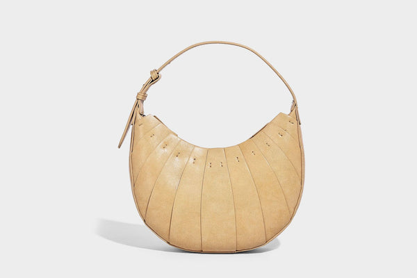 Crescent half-moon shoulder bag with vertical panel seaming, matte-satin leather-look finish, and adjustable gold-tone