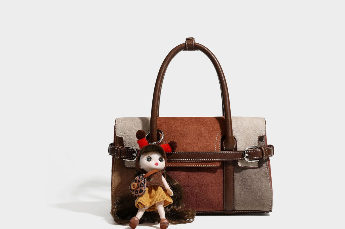 Structured color-block satchel bag in brown, rust, beige, and taupe suede-look panels with white topstitching, front buckle