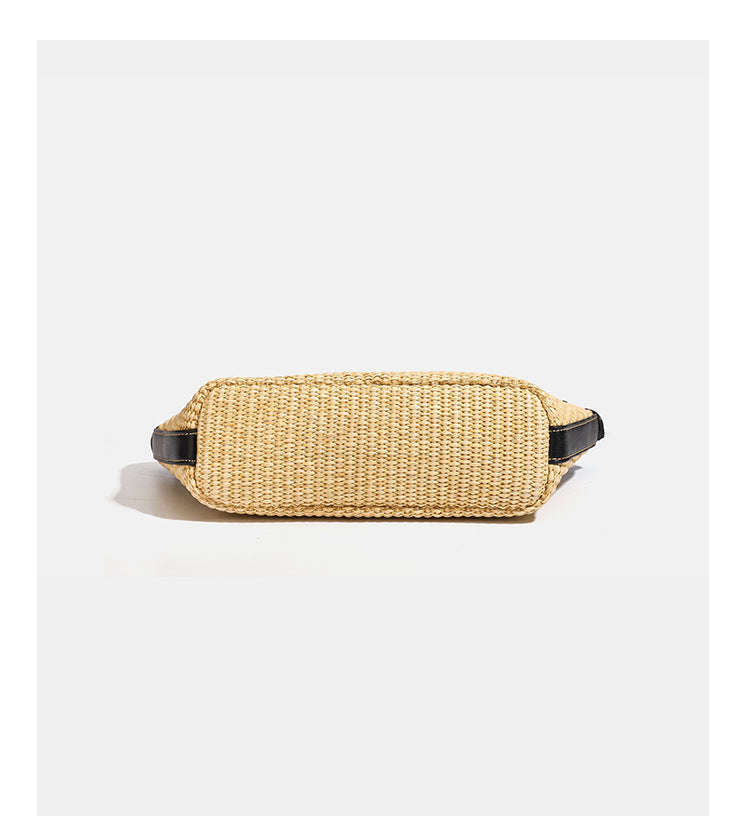 Structured tan woven straw tote bag with black leather-look trim, twin rounded top handles, gold-tone turn-lock front flap
