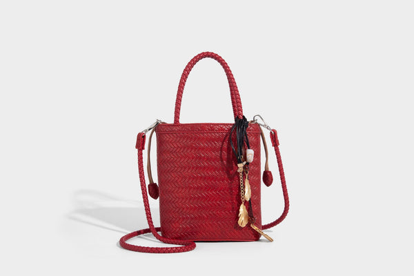 Small structured woven-texture tote bag with braided top handles and drawstring inner pouch, detail view 21