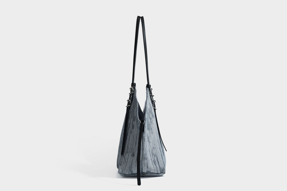 Large slouchy woven-texture shoulder tote bag with slim leather-look straps, side cinch ties, and silver-tone hardware