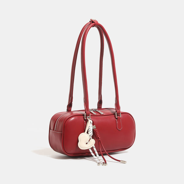 Compact rounded baguette shoulder bag with smooth leather-look finish, slim double straps, silver-tone zipper hardware, and