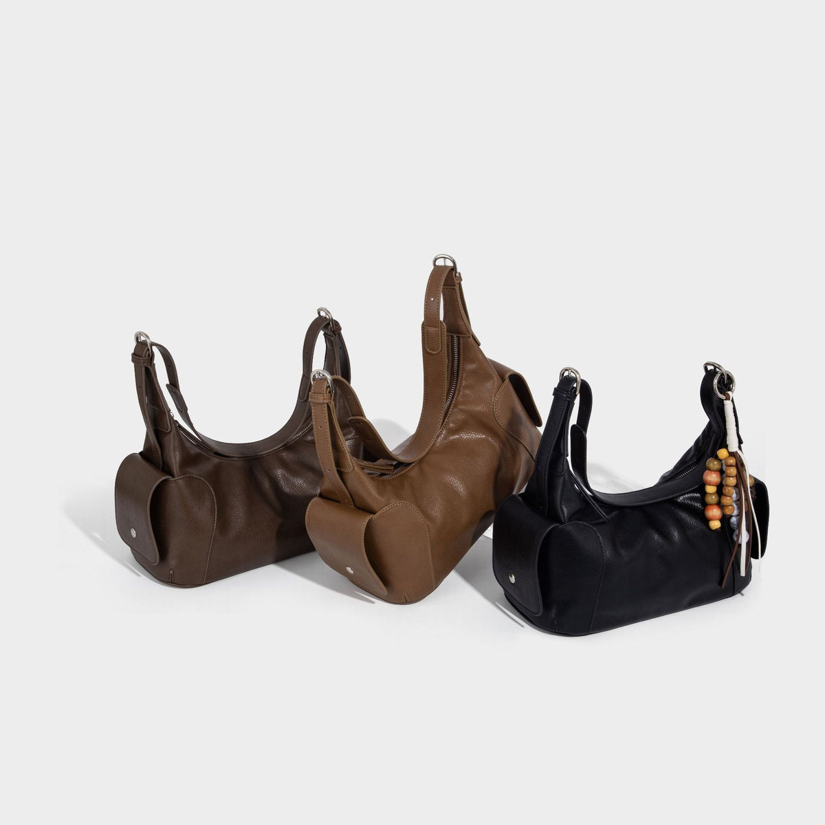 Soft pebbled leather-look hobo shoulder bag with zip top closure, side flap pockets, and silver-tone hardware, detail view 2