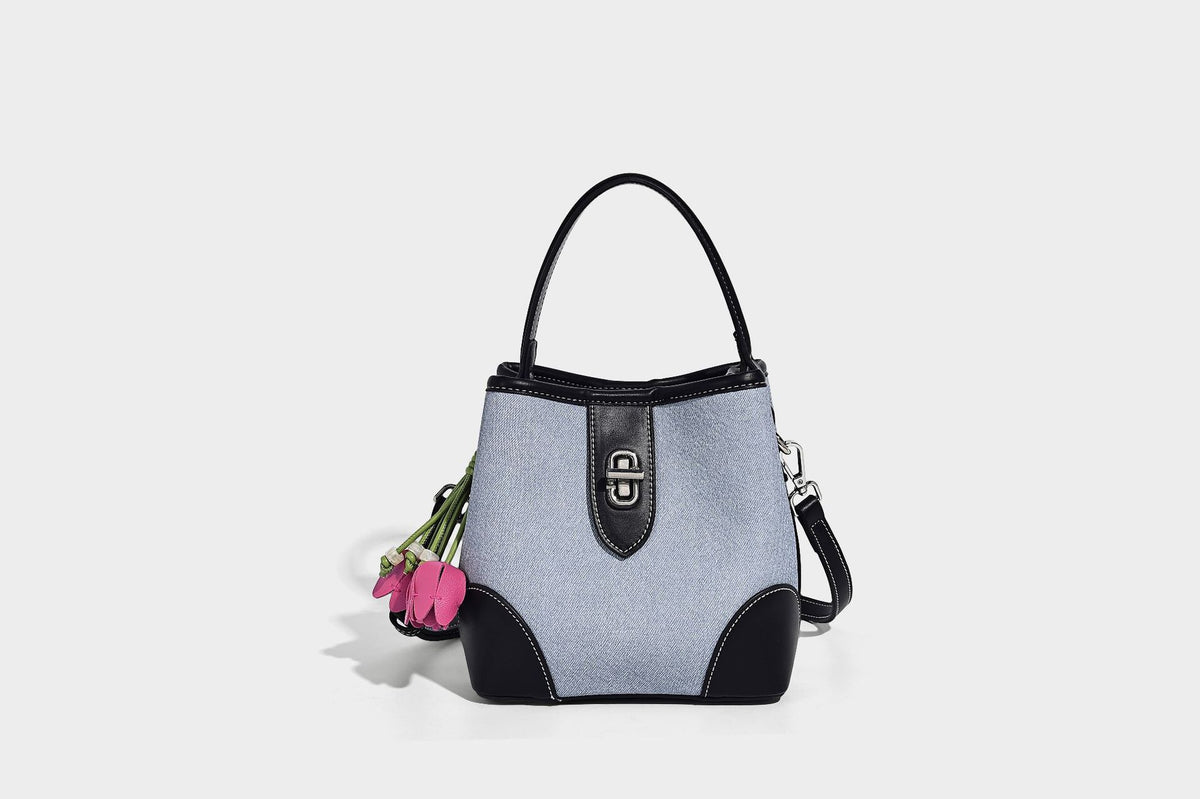 Small structured bucket bag in denim-look light blue fabric with black leather-look trim, silver turn-lock hardware, short
