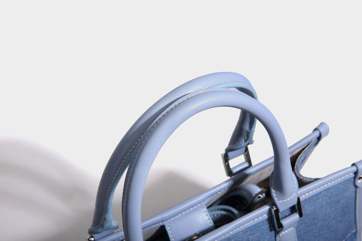 Structured patchwork denim tote bag with frayed panel seams, dual top handles, and silver-tone hardware, detail view 19