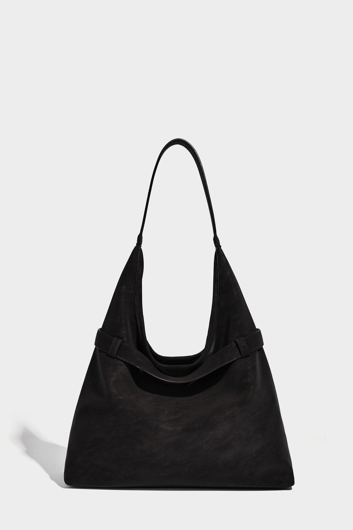 Slouchy oversized shoulder tote bag with matte textured finish, wrap-around buckle strap, and detachable front zip pouch