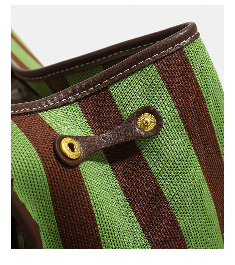 Structured striped canvas convertible satchel bag with leather-look trim, gold-tone buckle hardware, and backpack straps