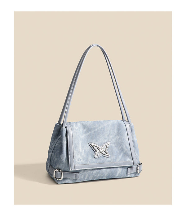 Washed leather-look shoulder tote bag with silver butterfly emblem and buckle hardware, detail view 12