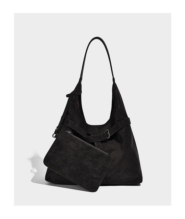 Slouchy oversized shoulder tote bag with matte textured finish, wrap-around buckle strap, and detachable front zip pouch