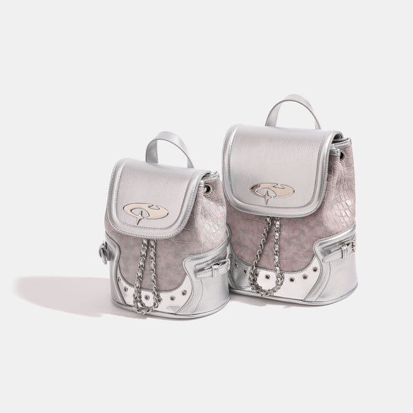 Croc-embossed mini backpack handbag with metallic silver flap, turn-lock closure, chain front detail, and top handle, front