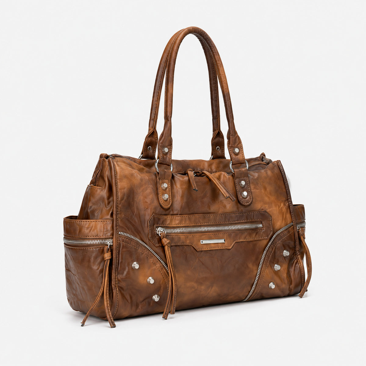 Large distressed leather-look moto tote bag with silver rivets, tassel zip pulls, front zip pocket, and dual top handles