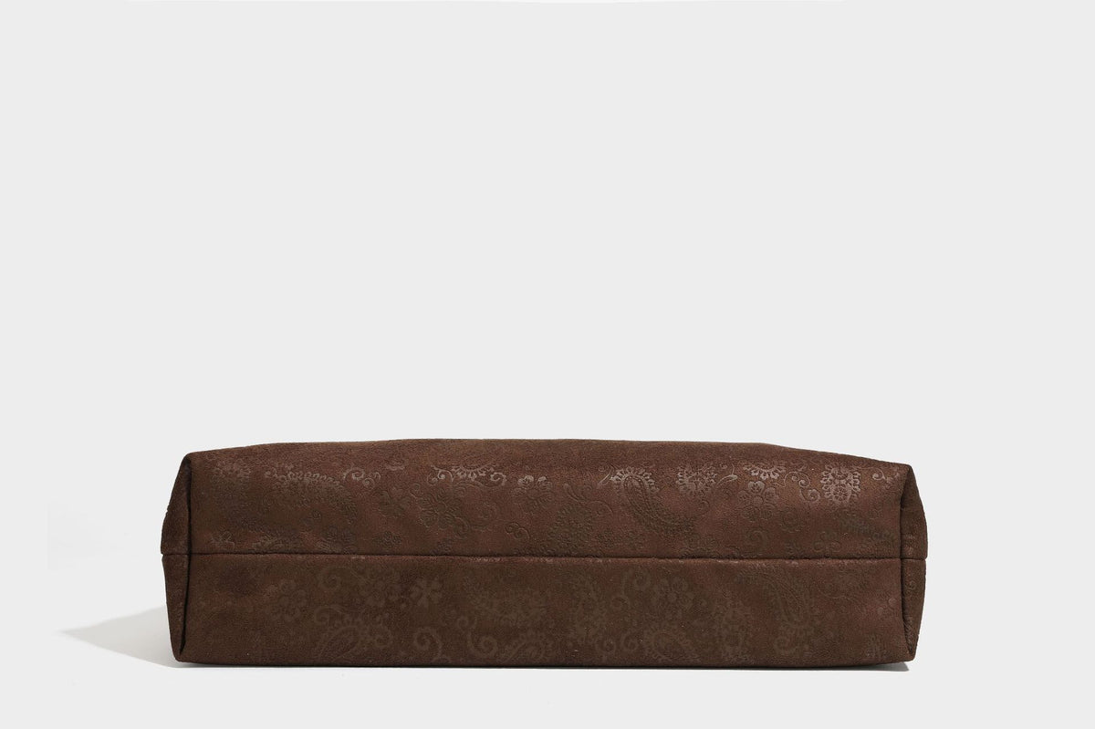 Slouchy boho hobo shoulder bag in embossed brown suede-look finish with beaded strap, cord tassels, and brass-tone leaf