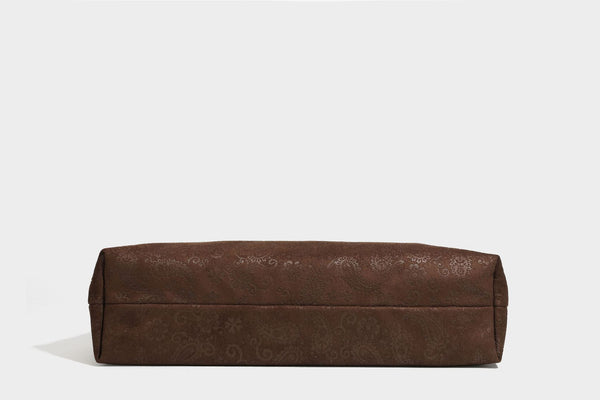Slouchy boho hobo shoulder bag in embossed brown suede-look finish with beaded strap, cord tassels, and brass-tone leaf