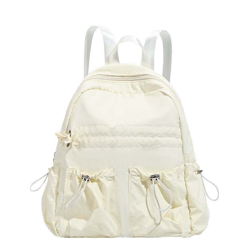 Puffy matte nylon mini backpack with drawcord gathered front pockets and silver-tone hardware, detail view 5