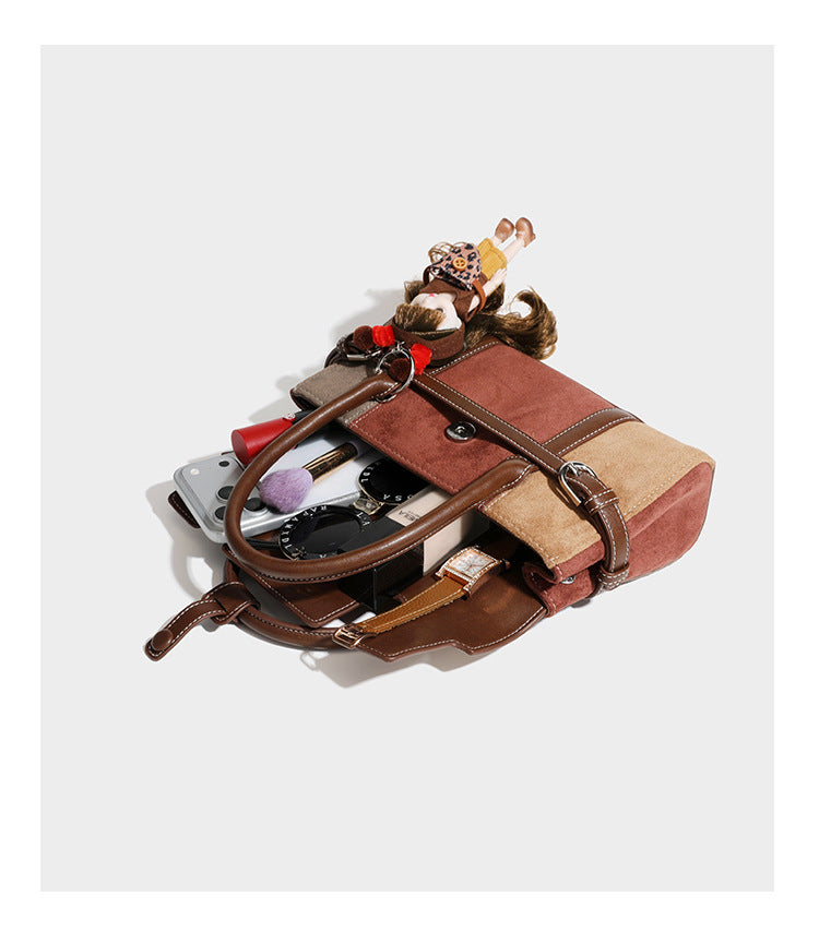 Structured color-block satchel bag in brown, rust, beige, and taupe suede-look panels with white topstitching, front buckle