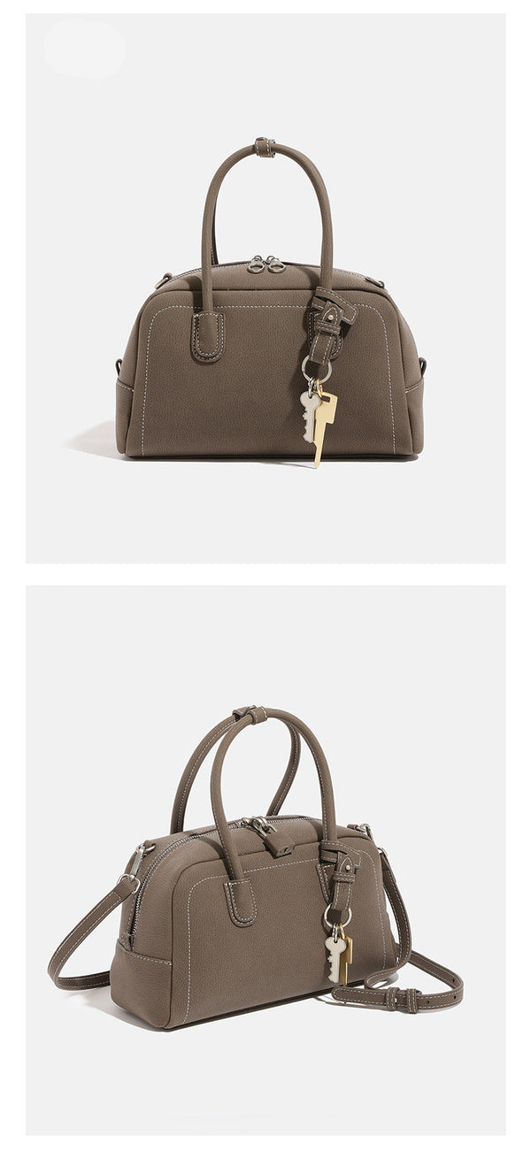 Compact retro Boston satchel bag with matte suede-look finish, twin rounded top handles, double zip closure with silver-tone