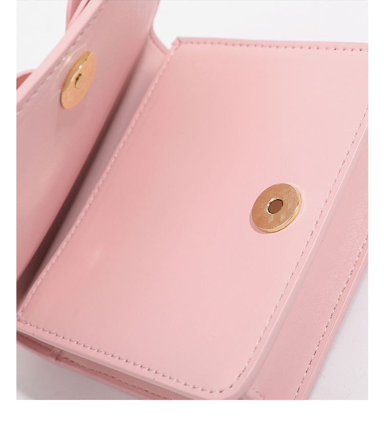 Small structured rectangular crossbody bag with layered 3D flower appliqué and gold-tone chain strap, detail view 20