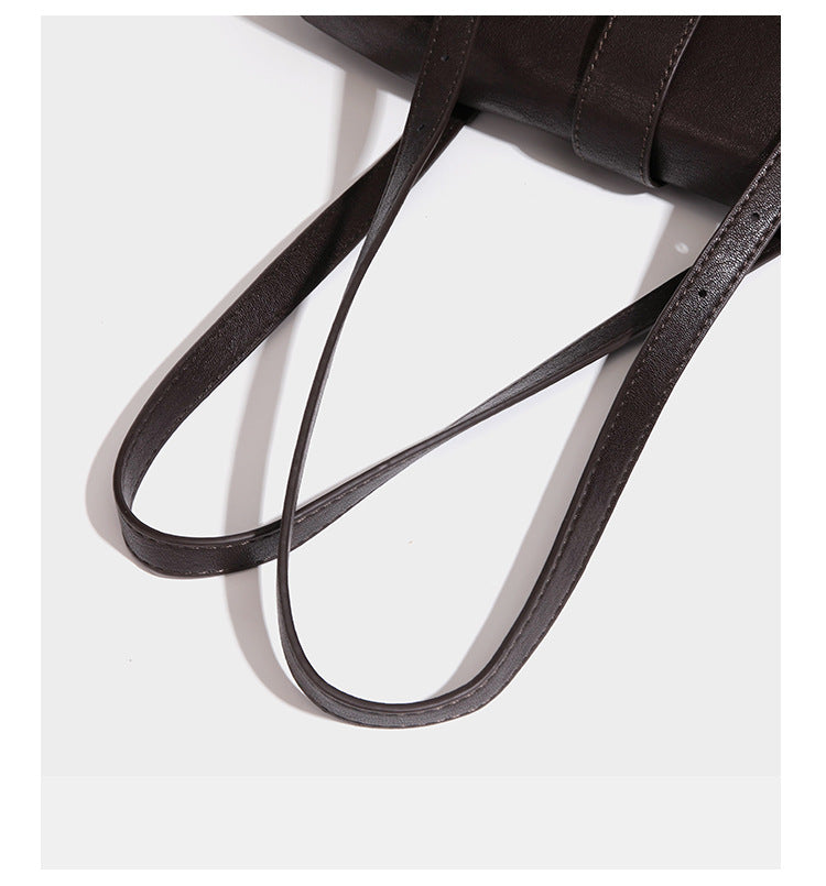 Large structured vintage-style tote bag with flap-front turn-lock closure, twin buckle straps, and double shoulder handles