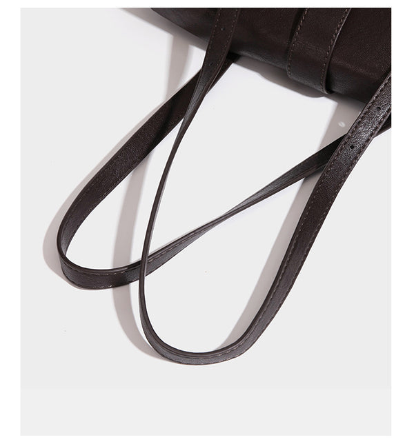 Large structured vintage-style tote bag with flap-front turn-lock closure, twin buckle straps, and double shoulder handles