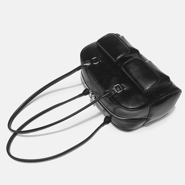 Structured glossy leather-look bowling shoulder bag with two front flap pockets, top zip closure, and long double shoulder