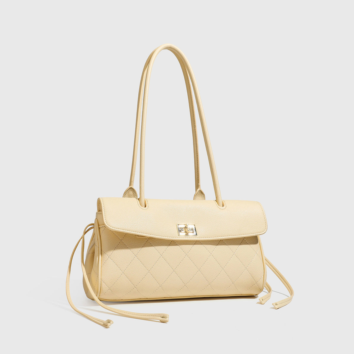 Structured black diamond-quilted shoulder bag with gold-tone turn-lock flap closure and dual round shoulder straps, detail