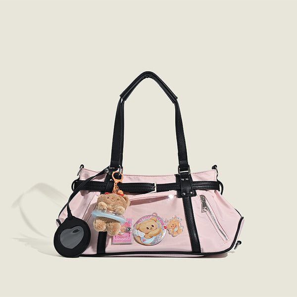 Pale pink nylon tote bag with black leather-look trim, double top handles, side zip pocket, and detachable crossbody strap