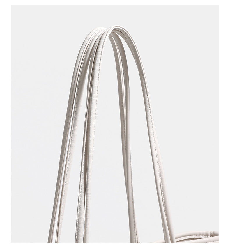 Off-white structured tote bag with dual shoulder straps, gold-tone hardware, and plush bear charm, detail view 14