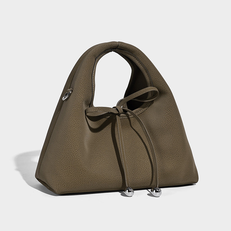 Pebbled matte trapezoid top-handle bag with drawstring bow closure, bead-tipped cords, silver-tone hardware, and detachable