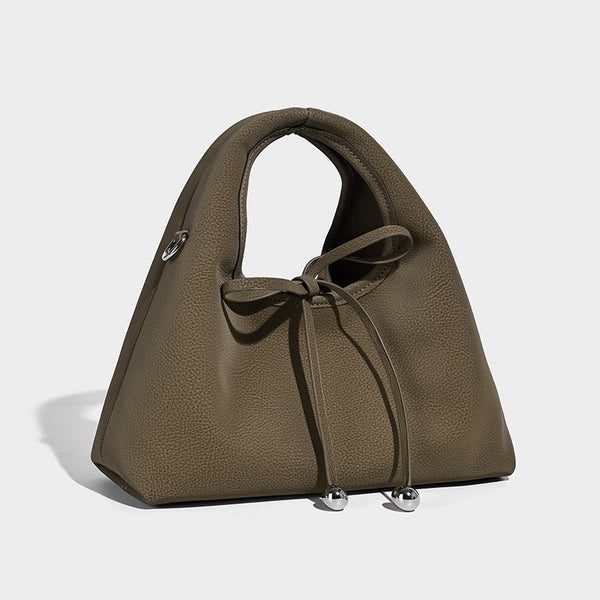 Pebbled matte trapezoid top-handle bag with drawstring bow closure, bead-tipped cords, silver-tone hardware, and detachable