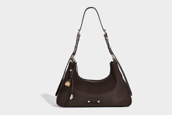 Crescent hobo shoulder bag in pebbled leather-look finish with top zipper, adjustable strap, gold-tone ring hardware, and