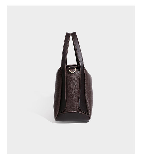 Structured pebbled leather-look shoulder bag with flap top, gold-tone emblem hardware, dual top handles, and detachable