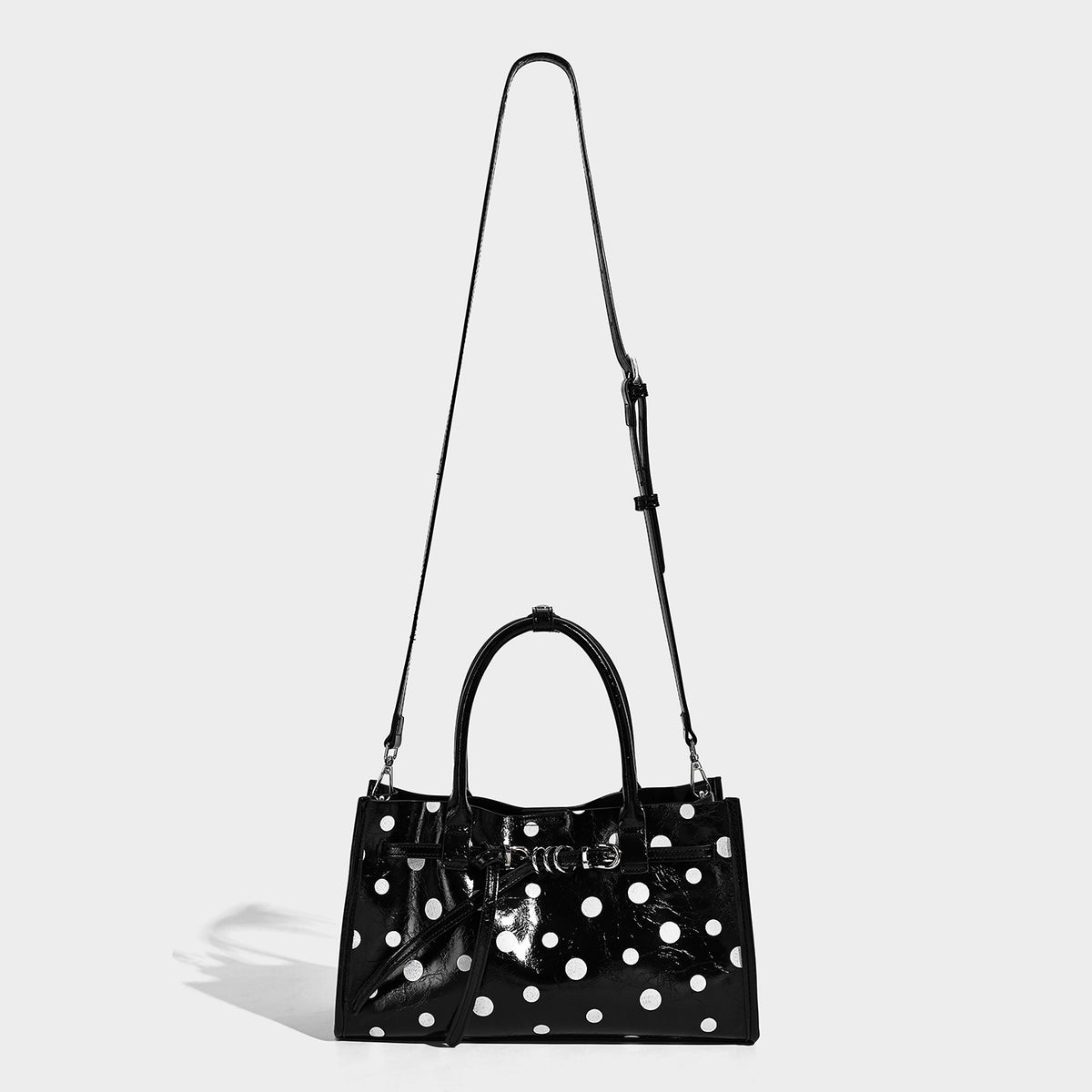 Structured glossy leather-look polka-dot satchel tote with dual top handles and detachable shoulder strap, detail view 4
