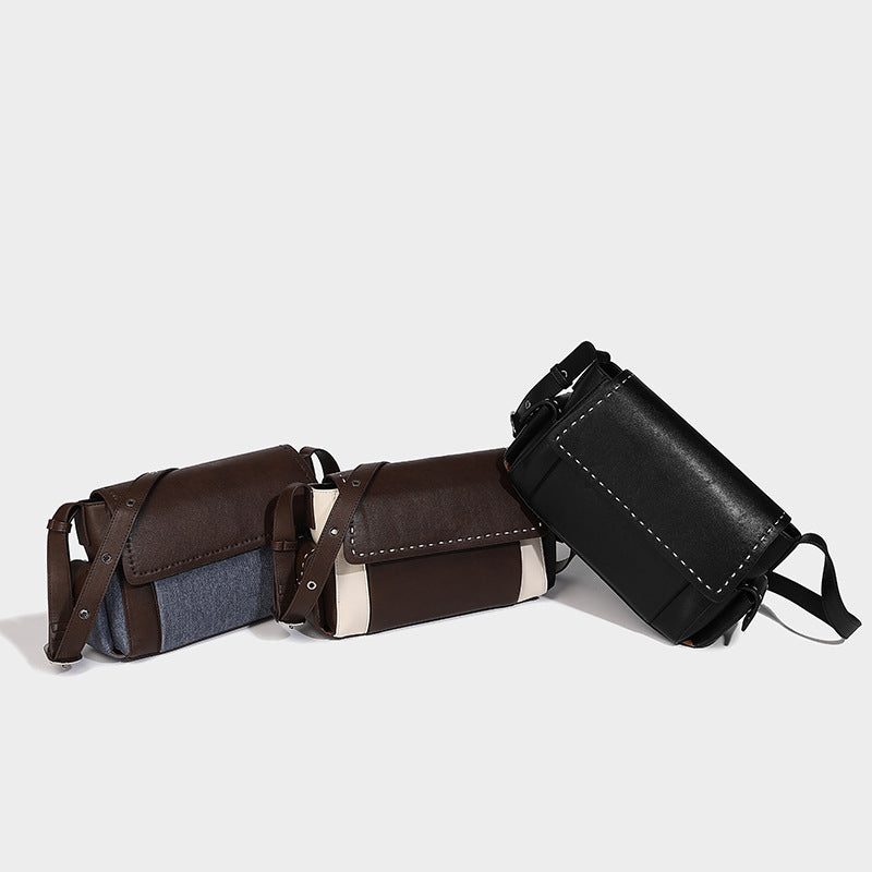 Structured flap crossbody bag in dark brown and cream color-block with white contrast stitching, adjustable shoulder strap