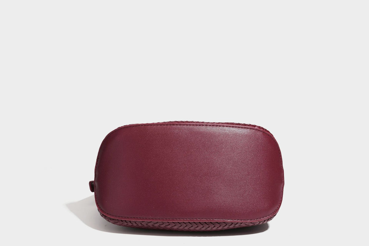 Small woven-look leather-look flap shoulder hobo bag in burgundy with silver-tone hardware and decorative tassel charm